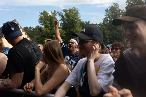 Mann reckt jubelnd die Faust in die Luft in der Menge